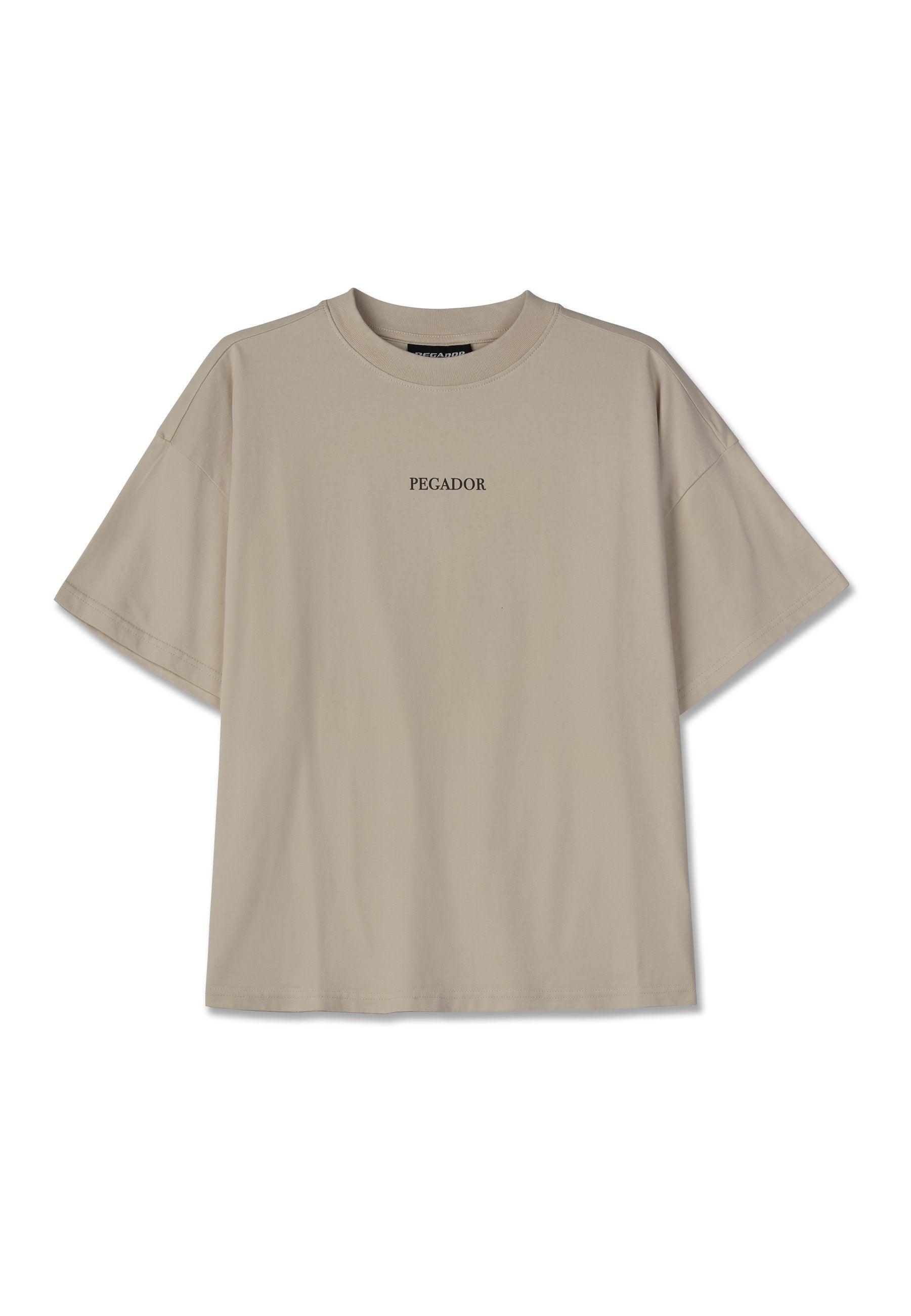 Beige Baumwoll-T-Shirt mit Oversize-Schnitt, kurzen Ärmeln, rundem Halsausschnitt und zentriertem schwarzen Text "PEGADOR." Keine Muster oder zusätzlichen Details.