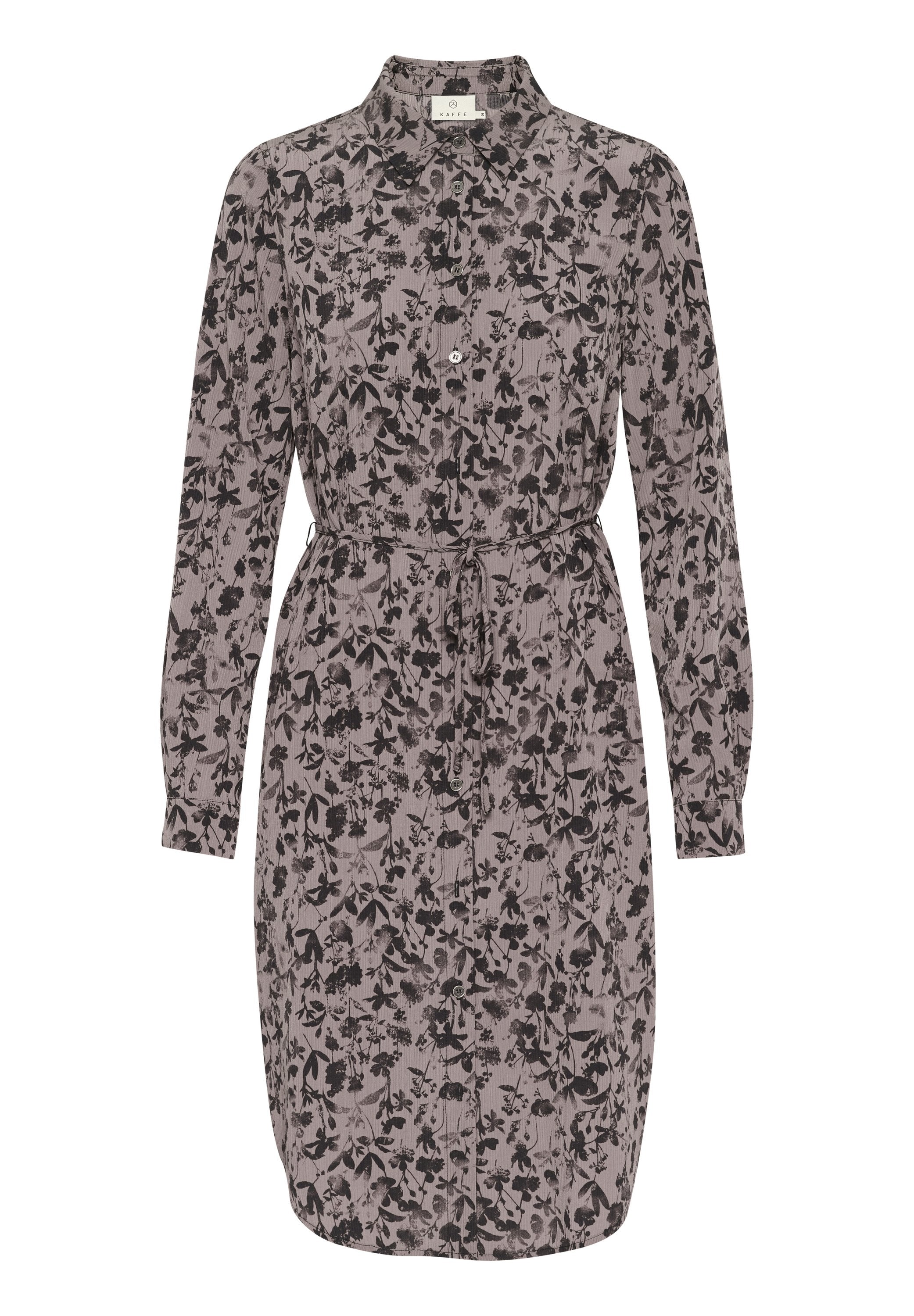 Langärmliges Kleid in hellem Mauve mit schwarzem Blumenmuster; verfügt über eine Knopfleiste vorne, einen Kragen und einen Zugbandbund zur Anpassung der Passform.