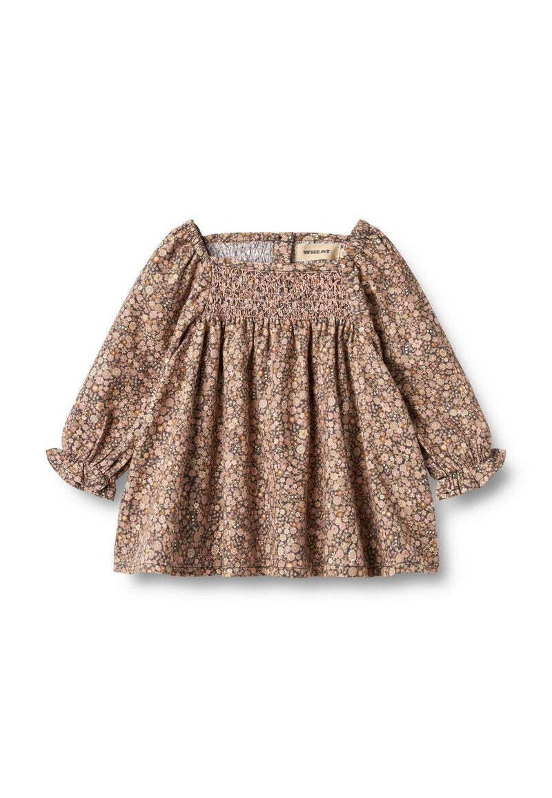 Braune Bluse mit floralem Muster, langen Ärmeln, rüschenartigem Oberteil und gerafftem Rock. Mit puffigen Ärmeln, elastischen Bündchen und quadratischem Ausschnitt.