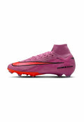 Rosa Hochschnitt-Fußballschuh mit roter Sohle, schwarzem Nike Swoosh und "AIR ZOOM"-Text an der Ferse, entworfen für das Spiel auf festem Boden.