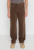 Mann trägt braune gerade geschnittene Hose mit Vorderseiten-Taschen und beige Sneakers, steht vor einem einfarbigen hellen Hintergrund.