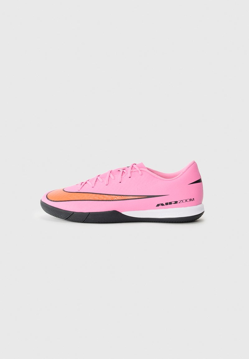 Rosa Sportschuh mit orangefarbenem Akzent, leichtes Design, strukturierte Oberfläche, schwarze Sohle und "AIR ZOOM"-Markierung an der Seite.