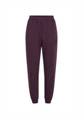 Violette Sweatpants mit elastischem Bund, gerippten Knöcheln und Seitentaschen. Mit dem Text "The Future Surf Society" in Schwarz an der Seite.