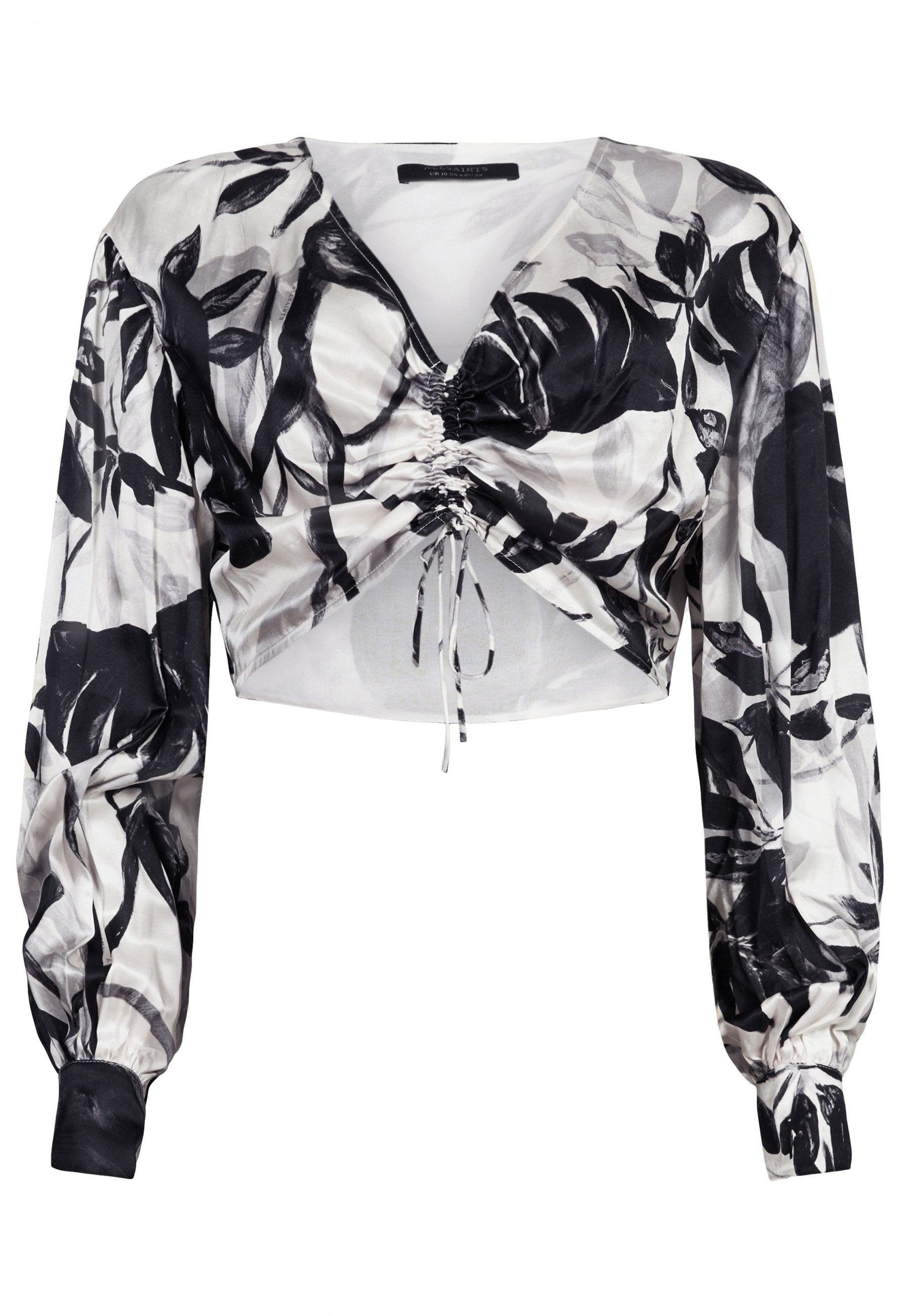 Schwarz-weißer Langarm-Crop-Top mit abstraktem Blattdruck und gerafftem Kordelzugdetail in der Mitte vorne.