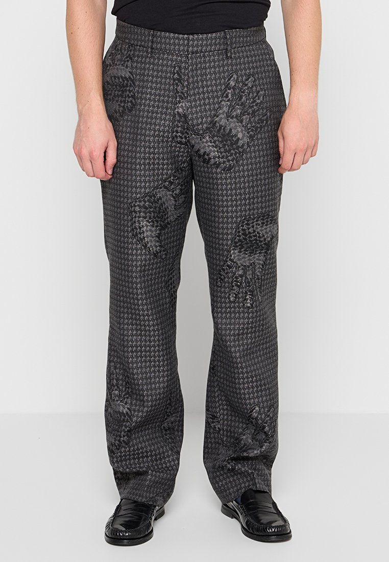 Schwarz-graue Hahnentritt-Hosenn mit einem strukturierten Muster und auffälligen Handabdruckdesigns. Gerade Beinform mit mittelhohem Bund.