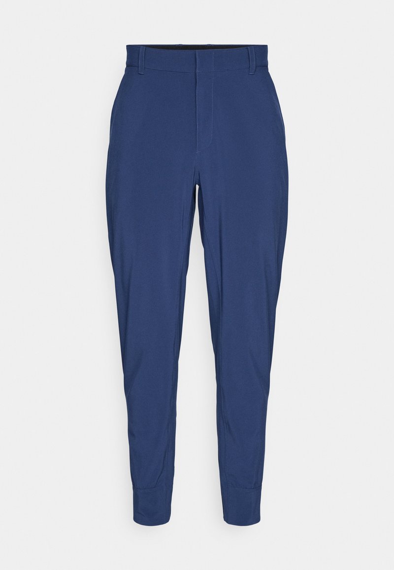 Marineblaue Hose aus glattem Stoff, mit flachem Frontschnitt, schmal zulaufenden Beinen und elastischem Bund. Keine sichtbaren Taschen oder Muster.