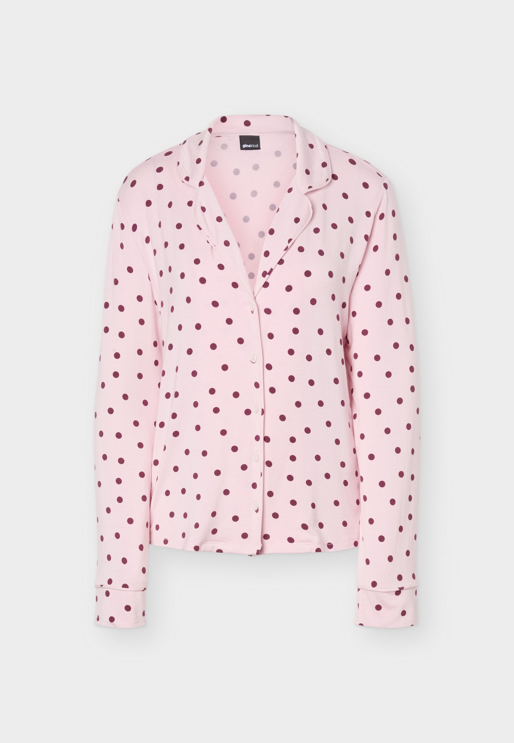 Rosa langärmeliges Pyjamaoberteil mit dunkelroten Punkten, Knopfleiste vorne und einem Reverskragen.