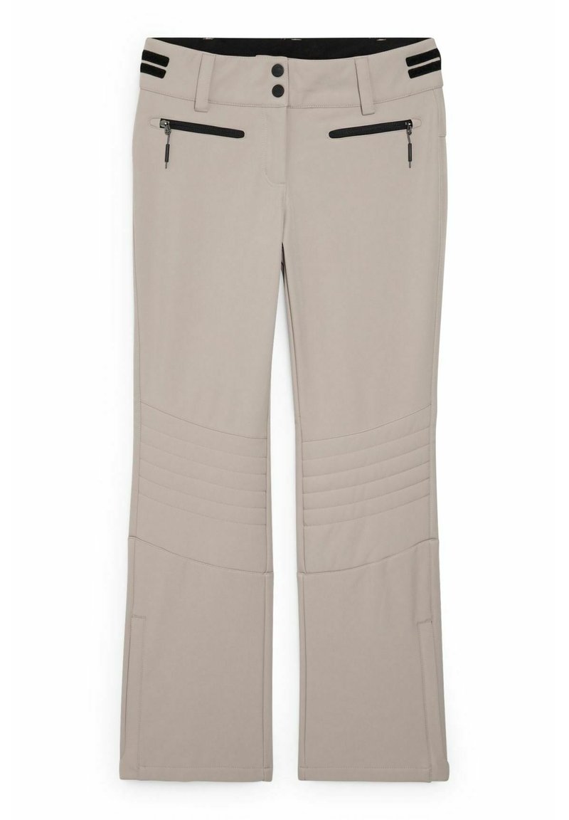 Beige Hosen mit schwarzen Taillenbunddetails, zwei vorderen Reißverschlusstaschen, doppeltem Knopfverschluss und gesteppten Kniefeldern.