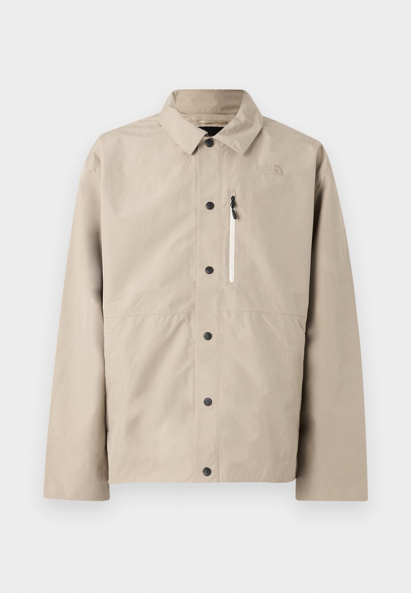 Beige North Face Hemdjacke mit Kragen und Reißverschlusstasche auf der Brust, entworfen für den Outdoor-Einsatz.