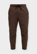 Nike Performance UNLIMITED - Tracksuit bottoms - baroque brown/black