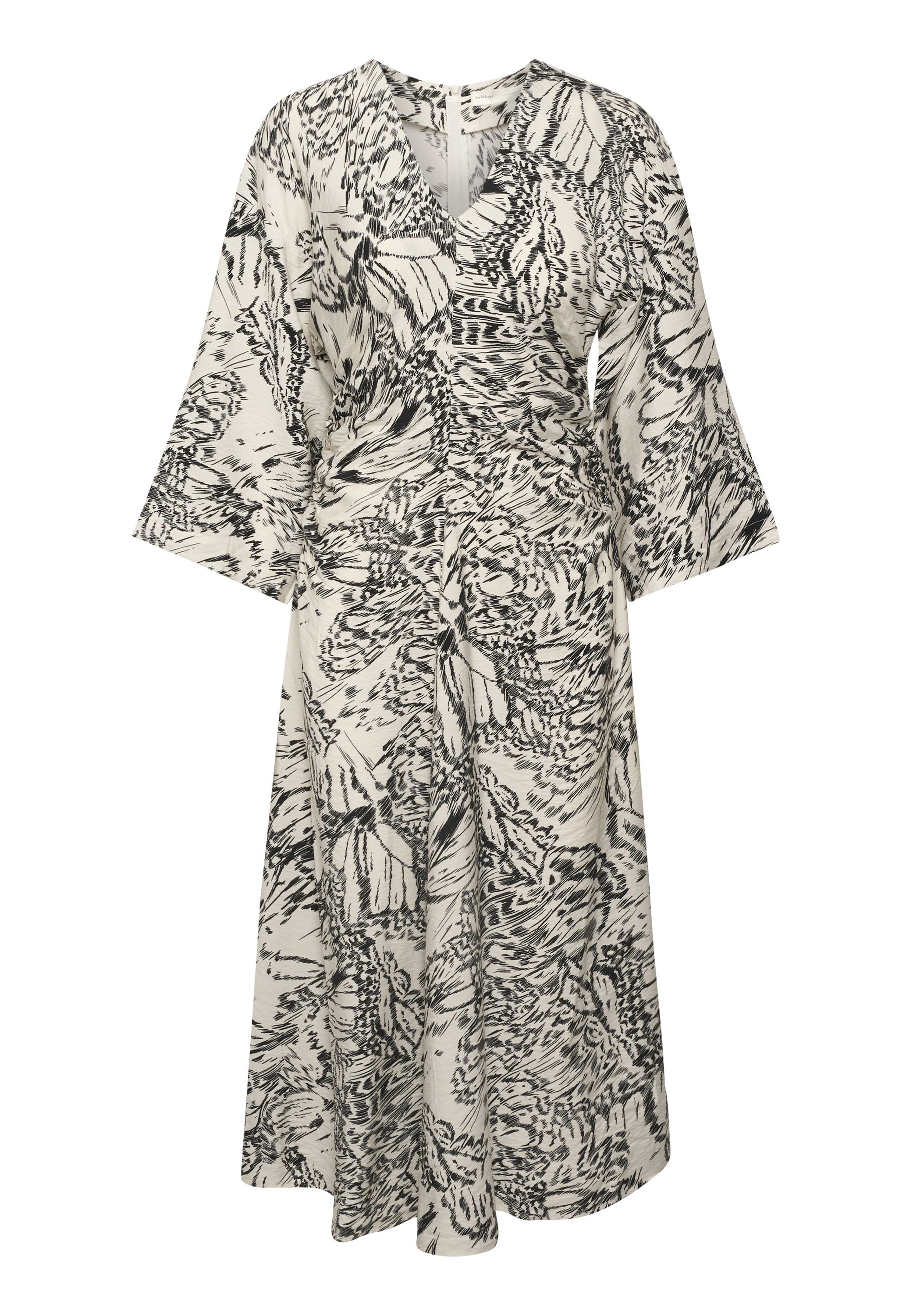 Maxikleid aus einem cremefarbenen Stoff mit schwarzem Blumenmuster; verfügt über einen V-Ausschnitt, lange Glockenärmel und eine taillierte Taille für eine fließende Silhouette.