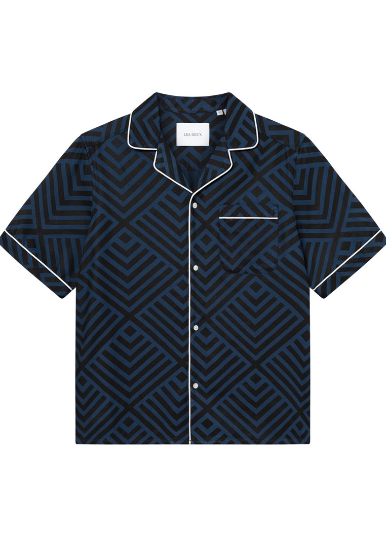 Kurzarmhemd aus navyblauem Stoff mit geometrischem Muster in Blautönen. Auffällige weiße Paspelierung am Kragen und an der Tasche.