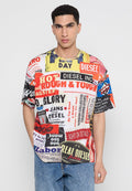 Mehrfarbiges übergroßes T-Shirt mit verschiedenen Grafikdrucken und Texten in Rot, Gelb, Schwarz und Blau. Aus Baumwollmaterial, mit kurzen Ärmeln.