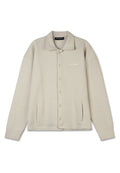 Beige Hemdjacke mit strukturiertem Muster, großem Kragen, zwei Fronttaschen und einem dezenten Logo auf der Brust. Weicher Stoff.