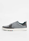 Grauer Sneaker aus Leder und Wildleder mit Perforationen, Schnürdesign, weißer Sohle, grünen Akzenten am Kragen und mehrfarbiger Streifen an der Sohle.