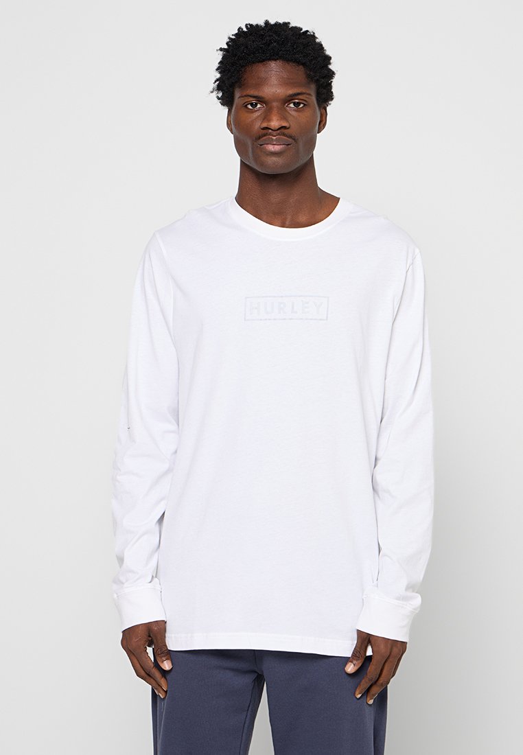 Weißes Langarmshirt aus Baumwolle mit einem dezenten Hurley-Logo in rechteckiger Form auf der Brust. Einfaches Design mit klassischem Rundhalsausschnitt.
