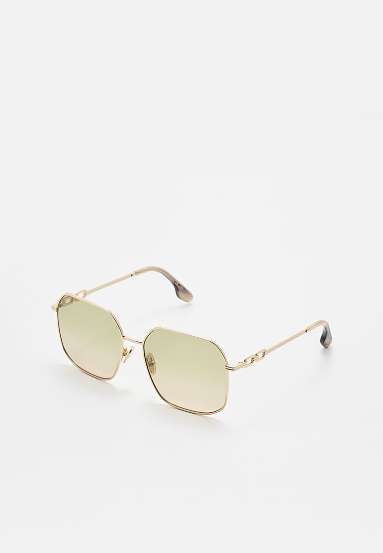 Goldene Metallsonnenbrille mit einem achteckigen Rahmen und Verlaufstönung in Grüntönen. Mit Kettenglied-Detailierung an den Bügeln und dunklen Enden.