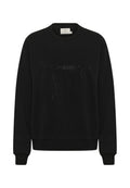 Schwarzer Pullover mit Rundhalsausschnitt, langen Ärmeln und gerippten Bündchen. Auf der Vorderseite befindet sich ein funkelförmiges Schleifenmuster, das aus kleinen Verzierungen besteht.