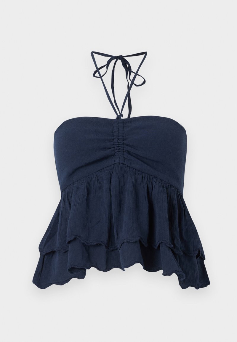 Navyblaues trägerloses Oberteil mit gefaltetem Oberteil, fransigem Saum und dünnen Halsschlaufen. Weicher, texturierter Stoff mit lockerer Passform, ideal für die Freizeit.