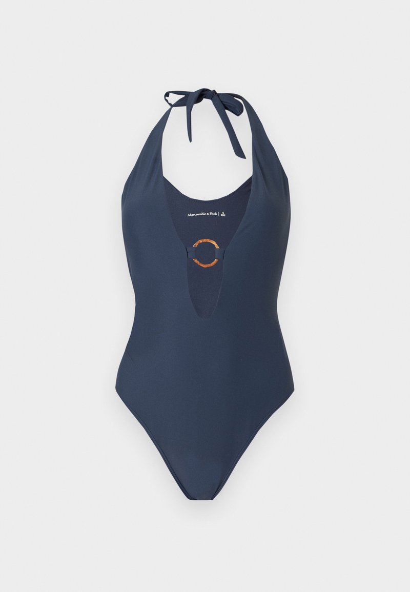 Marineblauer Einteiler mit Neckholder, tiefem V-Ausschnitt und dekorativem rundem Ringdetail vorne in der Mitte.