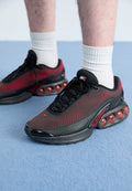 Nike Sportswear AIR MAX DN ESSENTIAL - Trainers - black/bright crimson/gym red