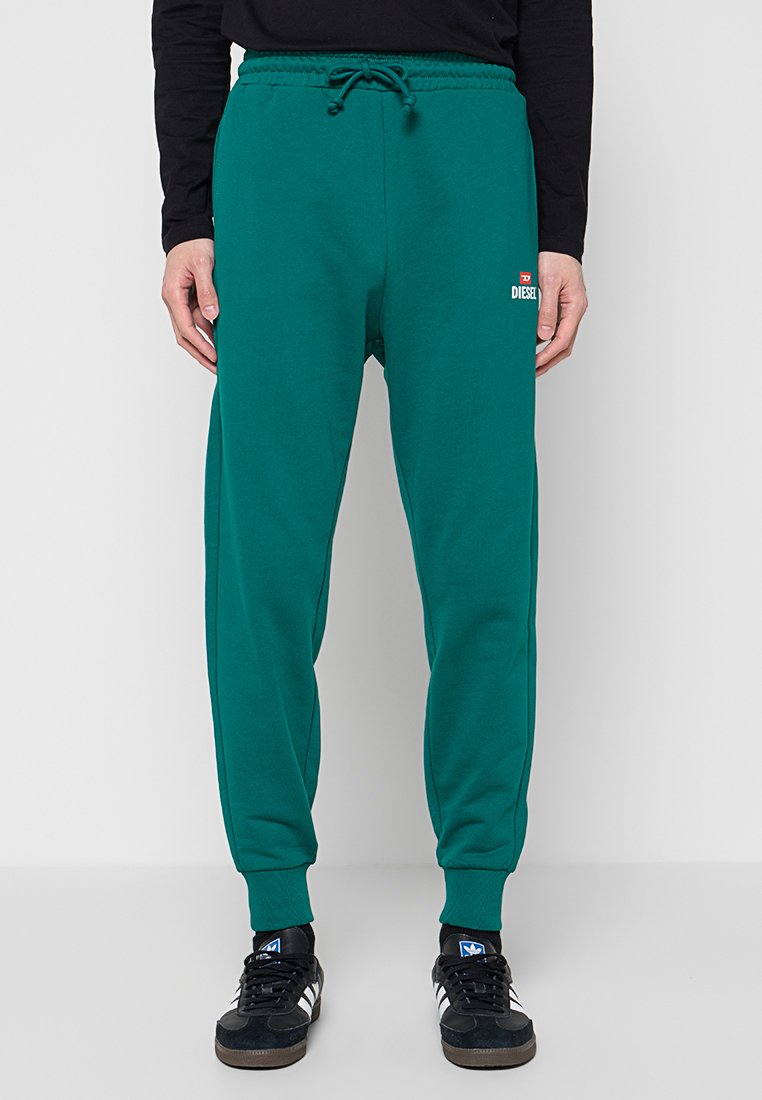 Türkisfarbene Jogginghose mit elastischem Bund, Kordelzug und Markenlogo. Hergestellt aus weichem Stoff mit schmal zulaufenden Beinen und gerippten Bündchen.