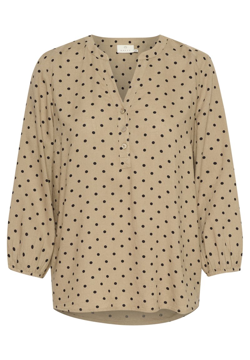 Beige Bluse mit Polka-Dots, V-Ausschnitt, Knopfleiste und langen Puffärmeln. Der Stoff hat eine strukturierte Oberfläche mit schwarzen, runden Mustern.