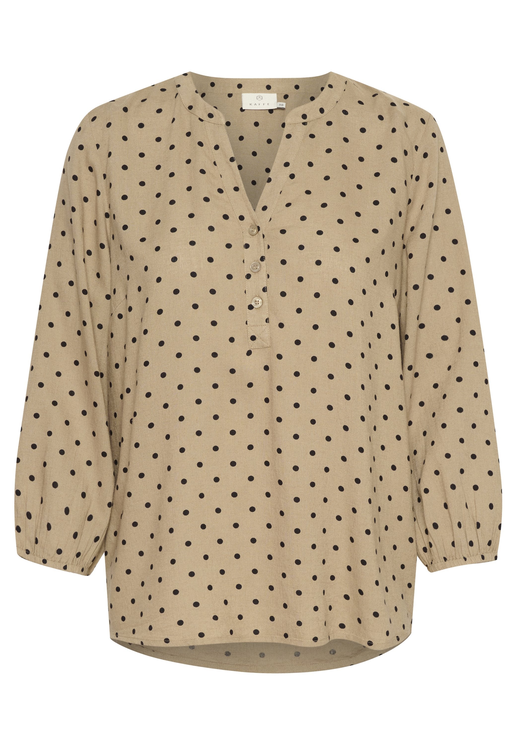 Beige Bluse mit Polka-Dots, V-Ausschnitt, Knopfleiste und langen Puffärmeln. Der Stoff hat eine strukturierte Oberfläche mit schwarzen, runden Mustern.