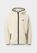 Cremfarbener Fleece-Hoodie mit Reißverschluss, schwarzem Besatz und Logopatch. Verfügt über Seitentaschen und einen weichen, strukturierten Stoff.