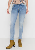 Helle blaue Skinny-Jeans aus Denim mit Auswaschungen, Fünf-Taschen-Design und glatter Textur, kombiniert mit braunen Stiefeln bis zum Knöchel.