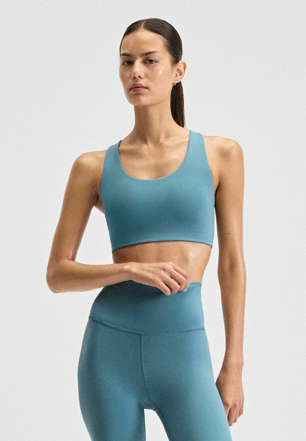 New Balance NB DEFINE TRAIN BRA - Medium support sports bra - big teal