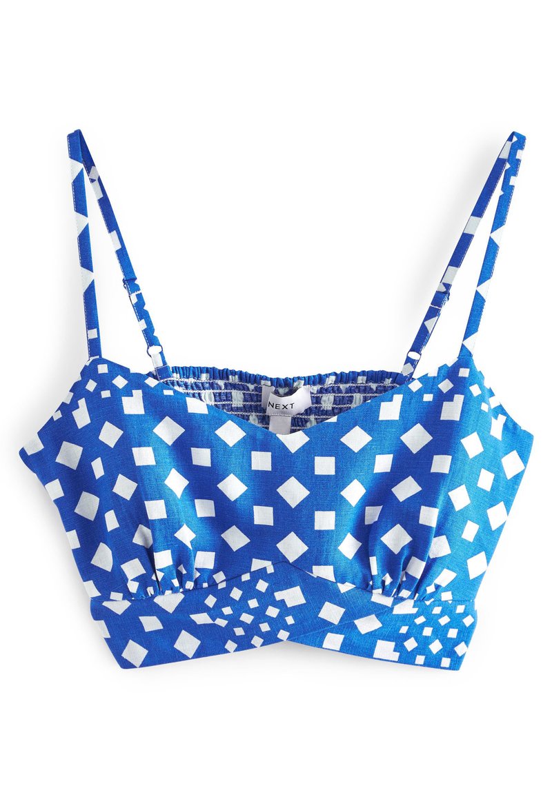 Blauer Bralette mit weißen geometrischen Mustern, ausgestattet mit dünnen verstellbaren Trägern, gepolsterten Cups und einem gesmokten elastischen Bund für einen sicheren Sitz.