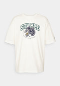 Puma STAPLE GRAPHIC TEE - Print T-shirt - warm white