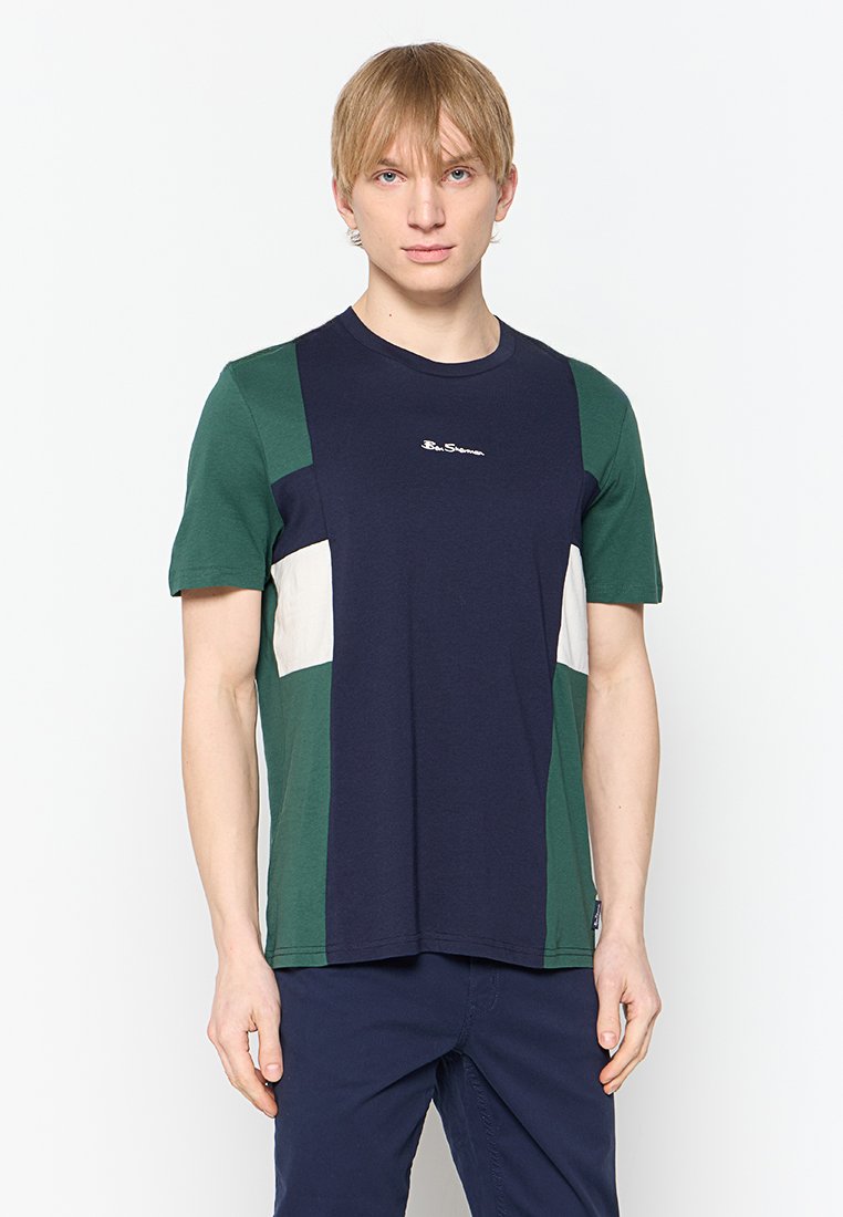 T-Shirt mit kurzen Ärmeln, das ein Blockdesign in Marineblau, Grün und Creme zeigt, aus Baumwollstoff mit rundem Ausschnitt.