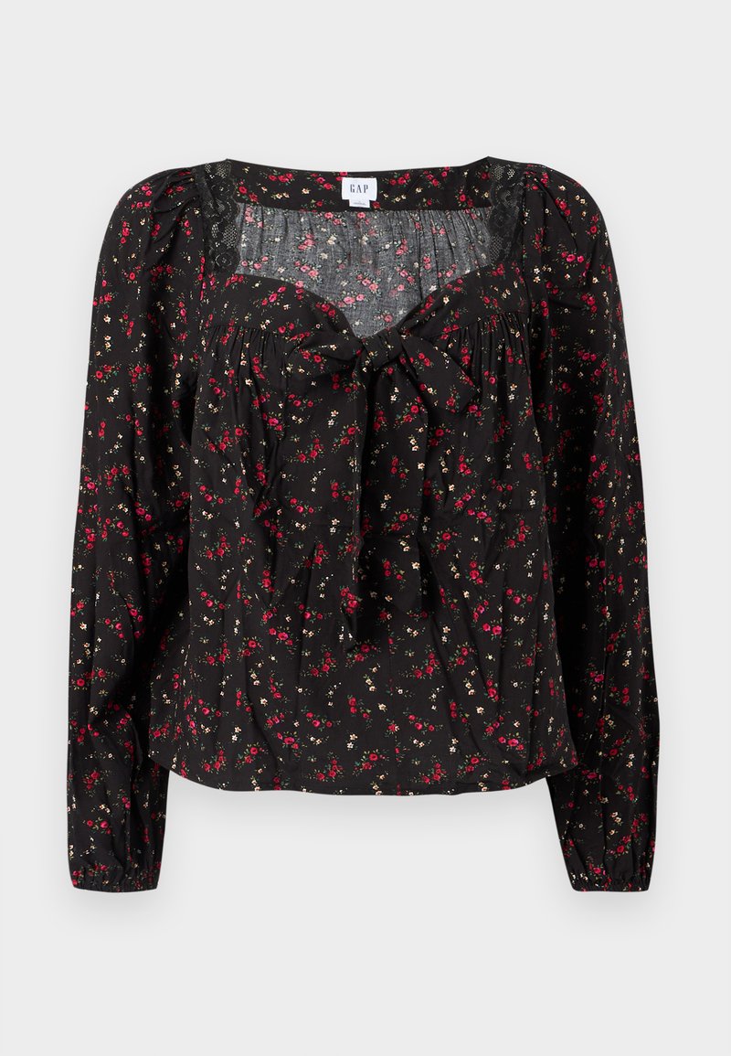 Schwarze Bluse mit Blumenmuster und langen Ärmeln, vorne mit Bindeband, gerafften Details und kleinen roten und weißen Blumenmustern auf der gesamten Fläche.