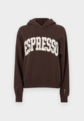 Brauner Hoodie mit einer vorderen Kängurutasche, versehen mit einem übergroßen "ESPRESSO"-Aufdruck in hellcremiger Farbe. Weicher Stoff und lockere Passform.