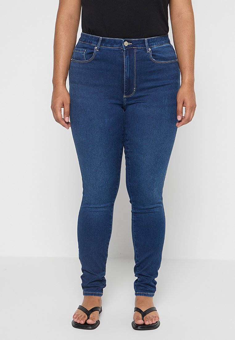 Blaue Denim-Skinny-Jeans mit mittelhohem Bund, fünf Taschen und dezenten Stitching-Details. Eng anliegend von der Taille bis zum Knöchel.