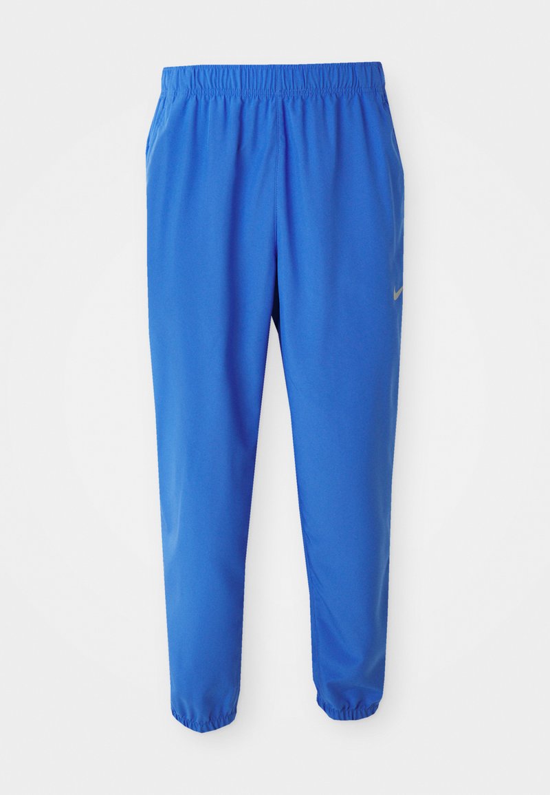 Blaue Sporthosen mit elastischem Bund, geradem Bein und schmal zulaufenden Säumen. Mit dem goldenen Nike-Logo auf der linken Seite.