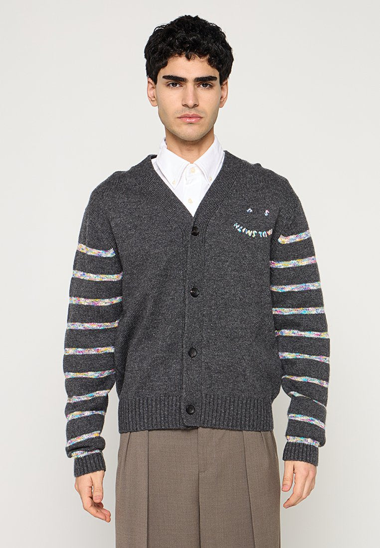 Graue gestrickte Strickjacke mit V-Ausschnitt, sechs schwarzen Knöpfen und mehrfarbigen gestreiften Ärmeln. Verfügt über dekorativen Text auf der Brust.