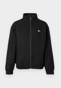 Schwarze Zip-Jacke aus weichem Stoff mit hohem Kragen. Verfügt über ein kleines Logo in Rot, Weiß und Blau. Elastische Bündchen und Saum.