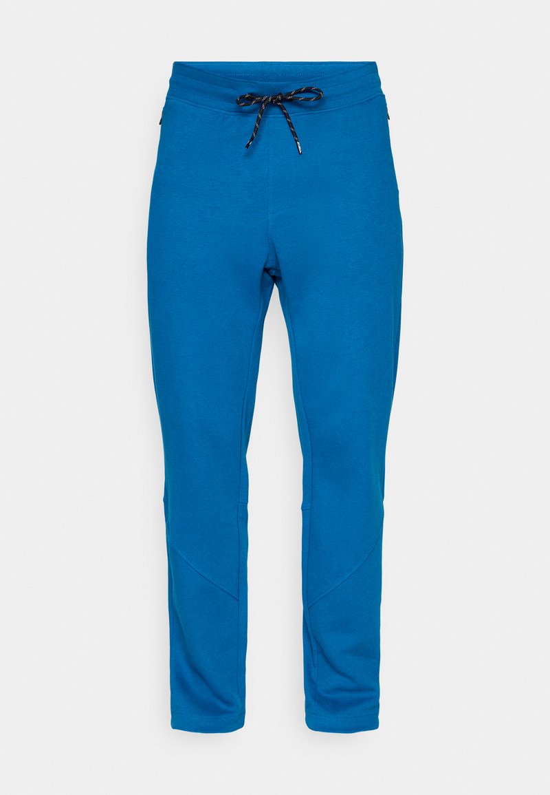 Blaue Slim-Fit-Sweatpants mit schwarzem und weißem Kordelzug, schmal zulaufenden Beinen und sichtbaren Nähten an den Knien.