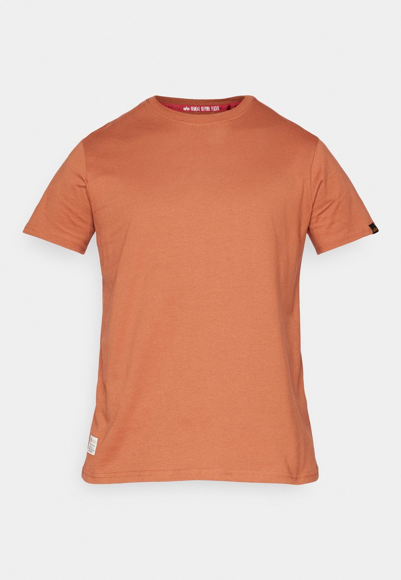 Kurzärmliges T-Shirt in rostorange, aus weicher Baumwolle, mit Rundhalsausschnitt und einem kleinen Etikett am unteren Saum.