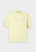 Helles gelbes kurzärmliges Baumwoll-T-Shirt mit erhabenem Text "Tommy Jeans Since 1985 New York City" auf der Brust.