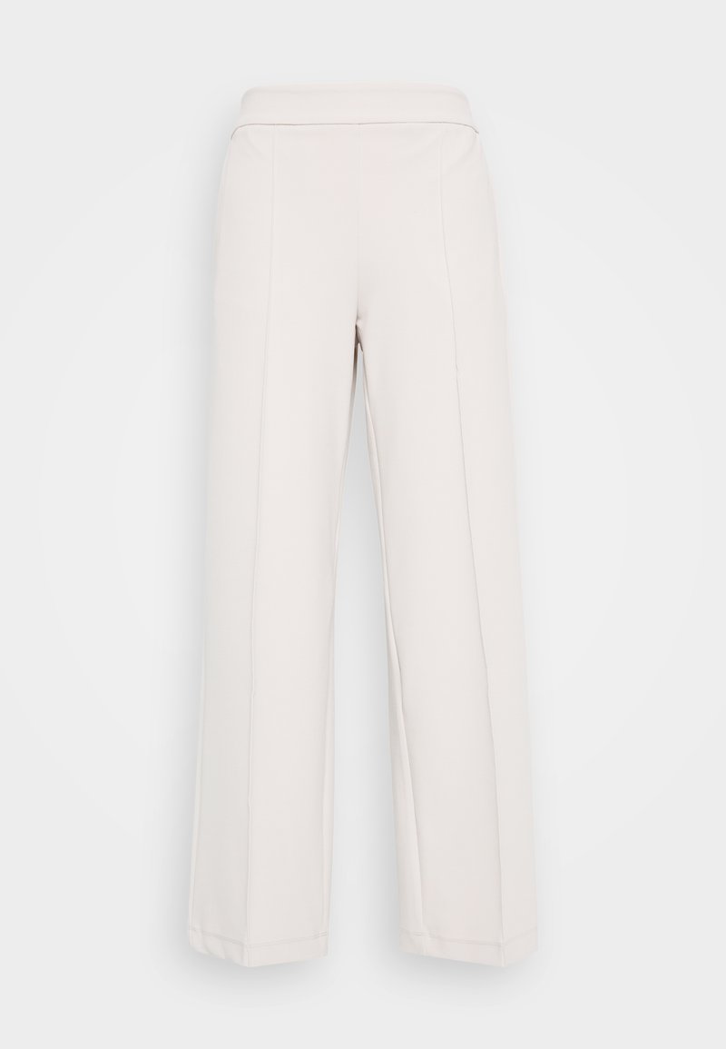 Hellbeige weite Hose aus weichem Stoff, mit einem glatten Bund und sichtbaren Nahtdetails an der Vorderseite.