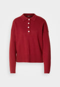 Roter Strickpullover mit Polo-Kragen, fünf weißen Knöpfen sowie gerippten Bündchen und Saum. Lockere Passform und weiche Textur.