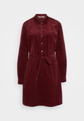 Kord Hemdkleid in tiefrot, mit Kragen, frontalen Knöpfen, langen Ärmeln, einem Taillengürtel und zwei Seitentaschen. Weiche Textur.
