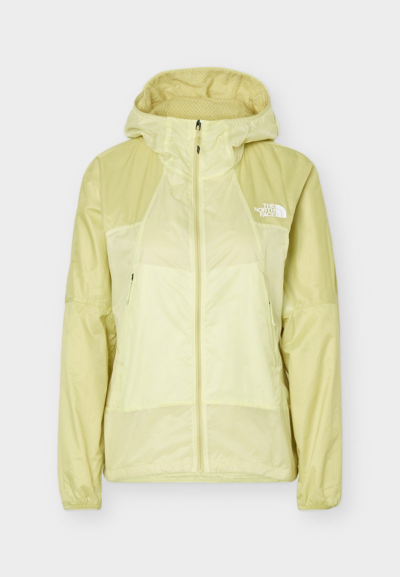 Hellgelbe Windjacke mit durchgehendem Reißverschluss, Kapuze, langen Ärmeln, zwei vorderen Reißverschlusstaschen und dem The North Face-Logo auf der linken Brust.