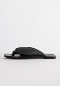 Schwarze Flip-Flop-Sandalen aus Leder mit einem weichen, geknoteten Oberriemen und flacher Gummisohle. Strukturiertes Grippmuster auf der Sohle.