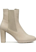 Beige Knöchelstiefel aus Wildleder mit einer glatten Oberfläche, seitlichen elastischen Einsätzen, einer spitzen Zehenpartie und einem klobigen hohen Absatz.