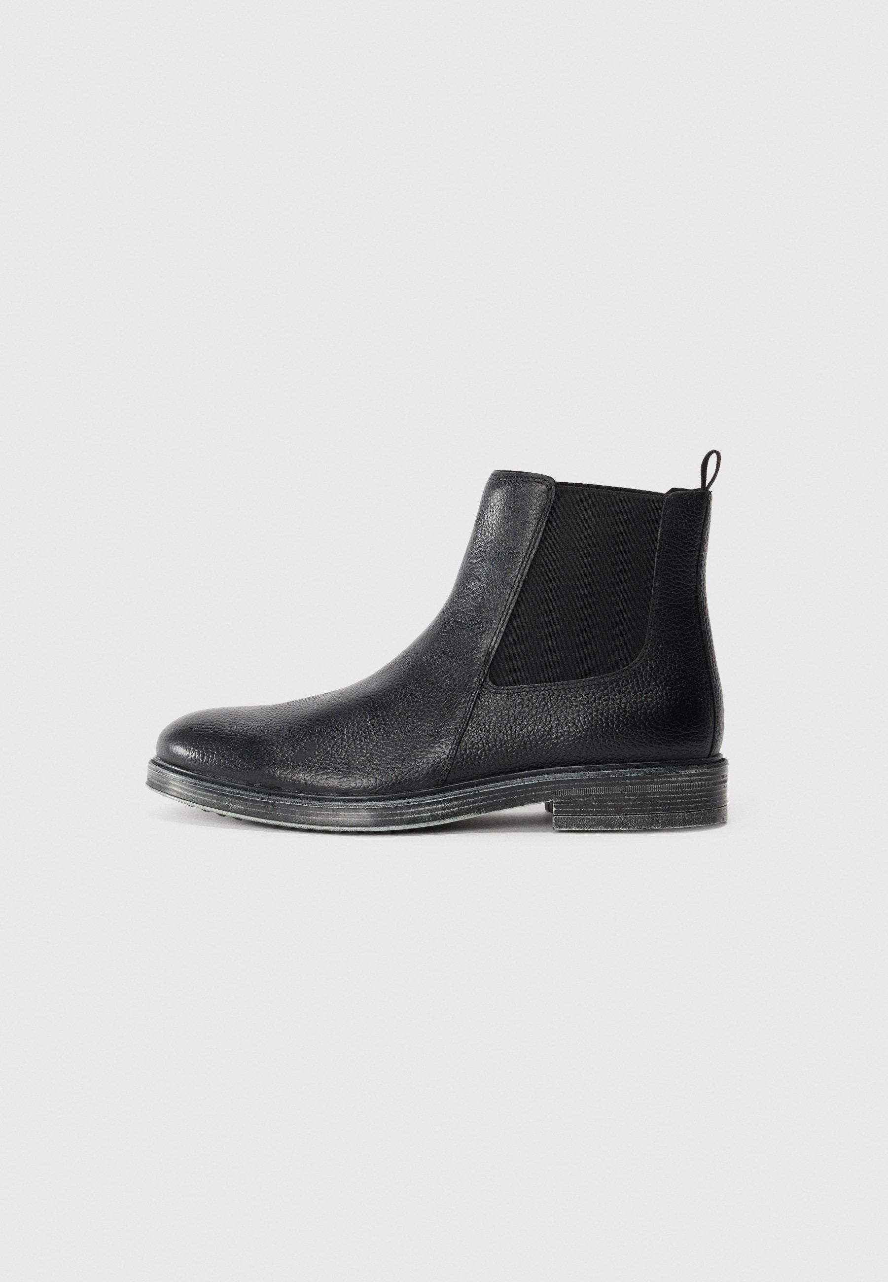 Schwarze Leder Chelsea-Boots mit strukturiertem Obermaterial, elastischen Seitenpanels und einer Anziehschlaufe. Verfügt über eine langlebige Sohle mit leichter Erhöhung.